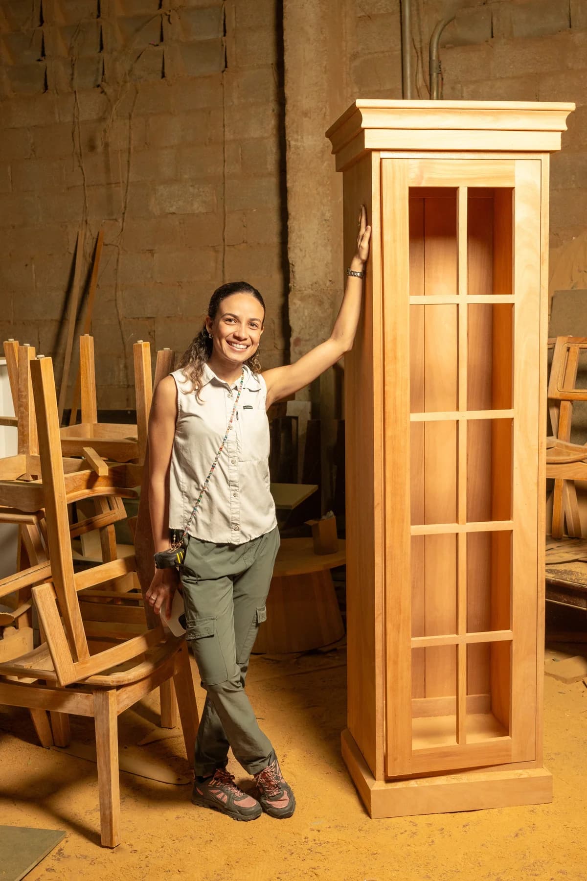 Pamela De Angelis in the Maderati workshop beside a handcrafted wood piece.